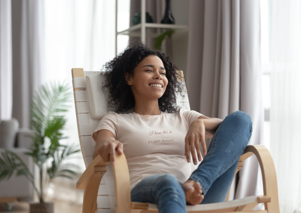 3 woman relaxing on chair looking very happy wearing a t-shirt with the slogan 'plan for a better tomorrow' ; living with intention for a brighter tomorrow